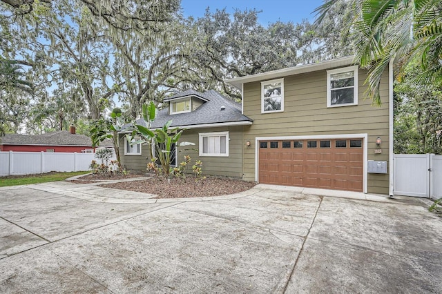 734 S Mills Ave, Orlando, FL 32801 - view of front facade with fence, a shingled roof, an attached garage, a gate, and driveway