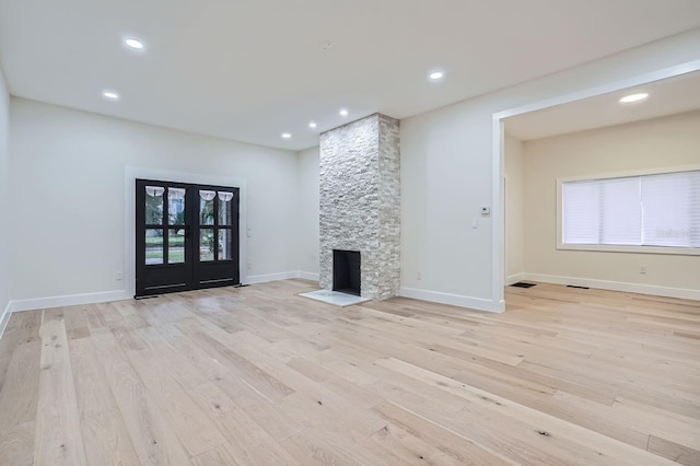 734 S Mills Ave, Orlando, FL 32801 - unfurnished living room with recessed lighting, baseboards, light wood-type flooring, and a stone fireplace
