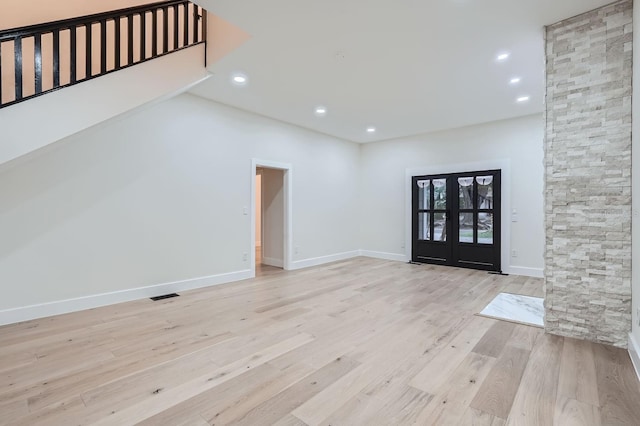 interior space with french doors and light wood-type flooring