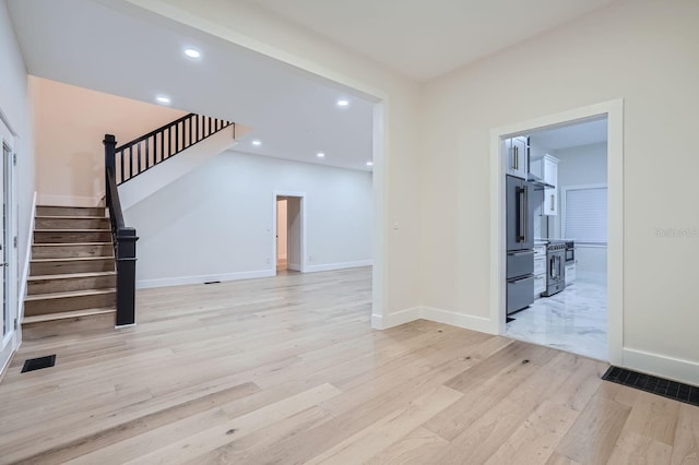 734 S Mills Ave, Orlando, FL 32801 - unfurnished living room featuring visible vents, light wood-style floors, baseboards, stairway, and recessed lighting