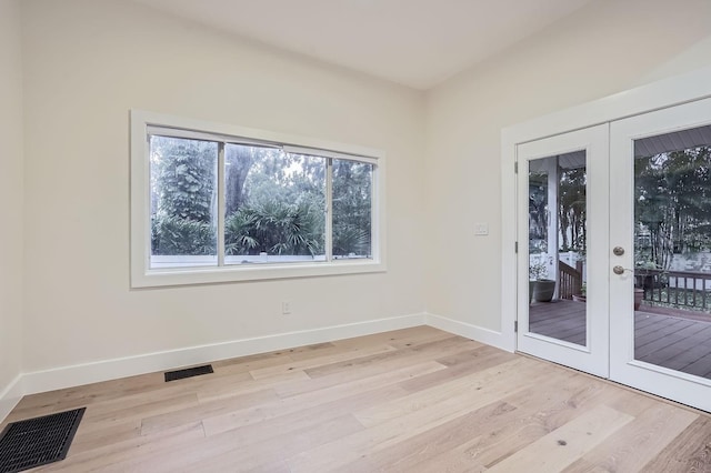 unfurnished room featuring light hardwood / wood-style flooring and french doors