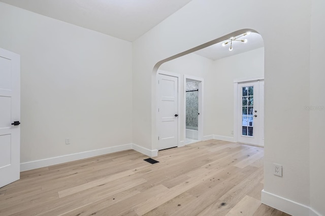 734 S Mills Ave, Orlando, FL 32801 - spare room with arched walkways, baseboards, light wood finished floors, and visible vents