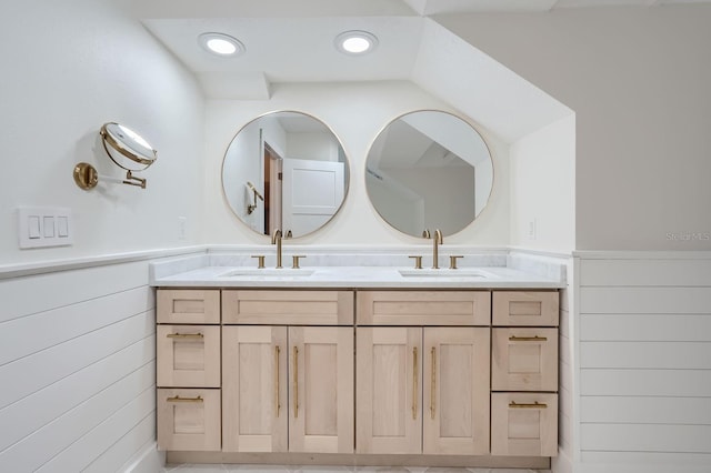 bathroom featuring vanity and wood walls