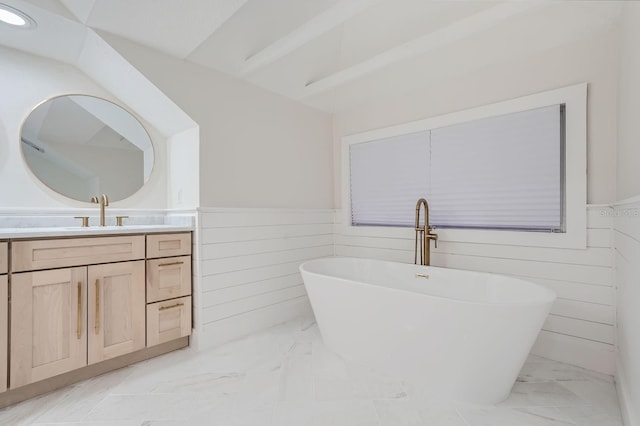 bathroom with vanity and a washtub