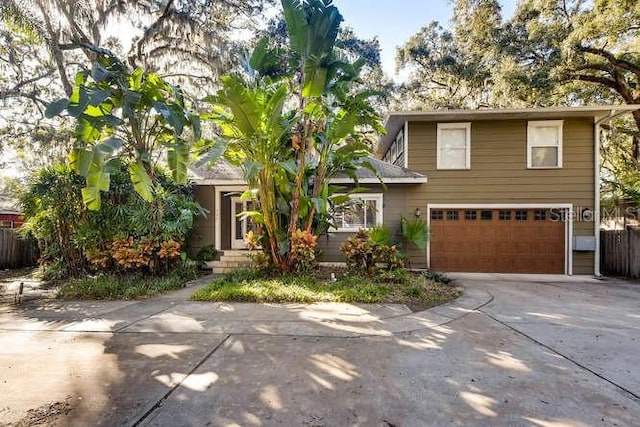 734 S Mills Ave, Orlando, FL 32801 - view of front of home with concrete driveway, fence, and a garage