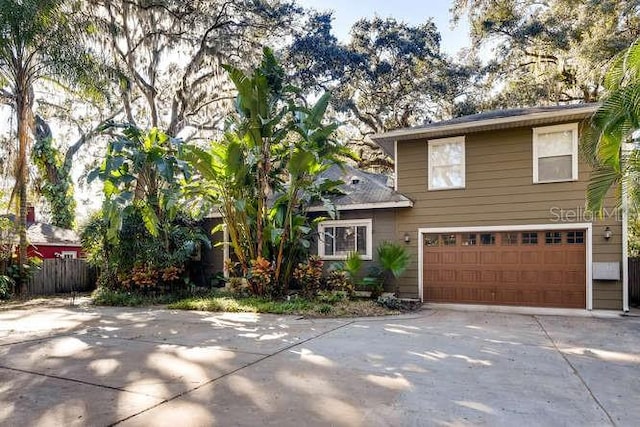 734 S Mills Ave, Orlando, FL 32801 - split level home featuring fence, an attached garage, and driveway