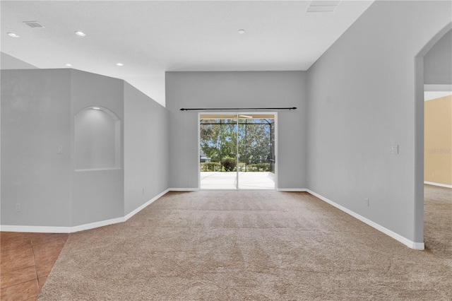 spare room featuring light colored carpet