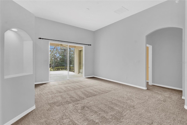 4538 Nottoway Dr, Leesburg, FL 34748 - unfurnished room with carpet, arched walkways, baseboards, and visible vents