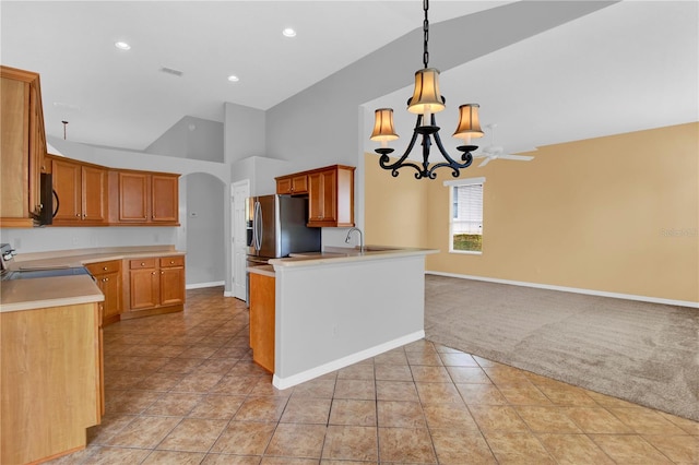 kitchen with light carpet, a notable chandelier, stainless steel fridge with ice dispenser, stove, and pendant lighting