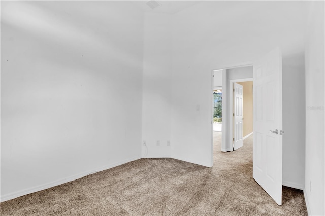 unfurnished room featuring light colored carpet