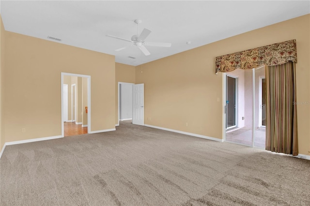 empty room featuring carpet flooring and ceiling fan