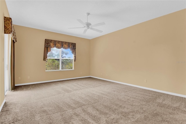 carpeted spare room featuring ceiling fan