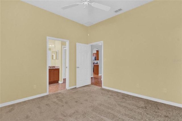 4538 Nottoway Dr, Leesburg, FL 34748 - unfurnished bedroom with light colored carpet, visible vents, baseboards, and arched walkways