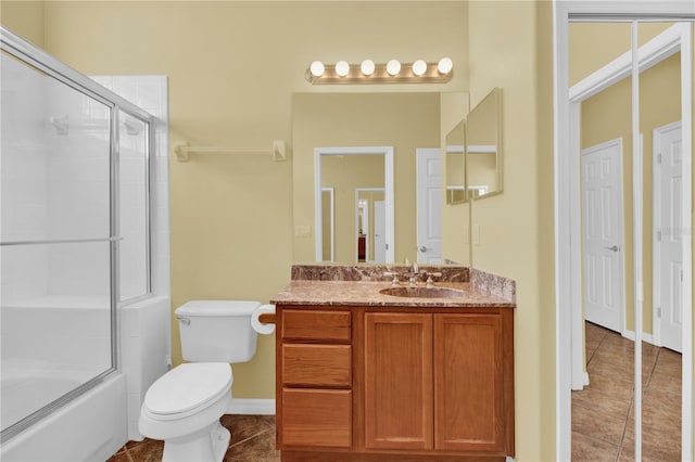 full bathroom featuring tile patterned flooring, vanity, combined bath / shower with glass door, and toilet