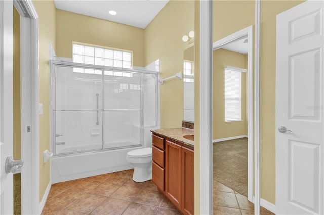 full bathroom with bath / shower combo with glass door, vanity, toilet, and tile patterned floors