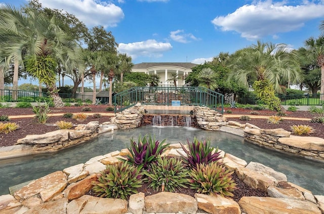 4538 Nottoway Dr, Leesburg, FL 34748 - view of community featuring a small pond and fence