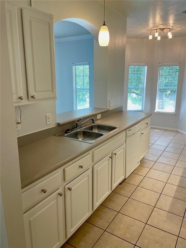 kitchen with pendant lighting, dishwasher, plenty of natural light, and white cabinets