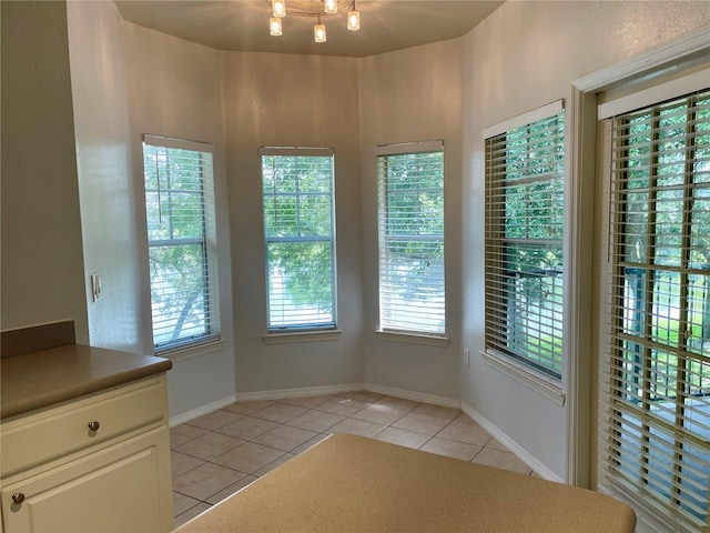 unfurnished dining area with plenty of natural light and light tile patterned floors