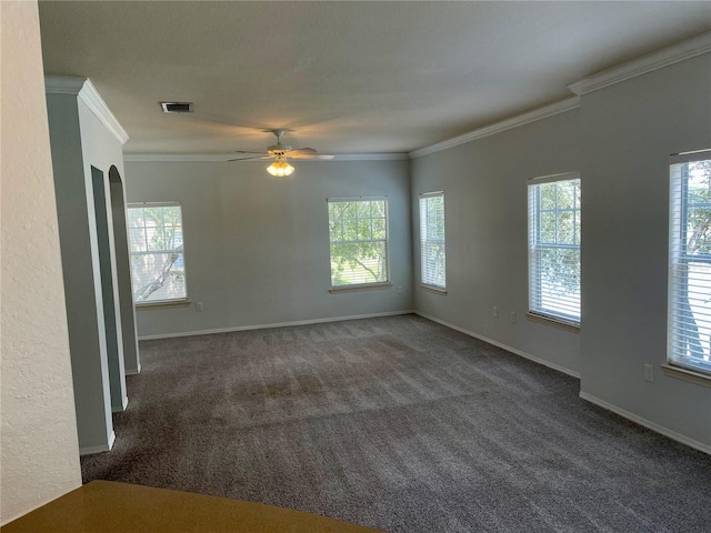 carpeted spare room featuring crown molding and ceiling fan