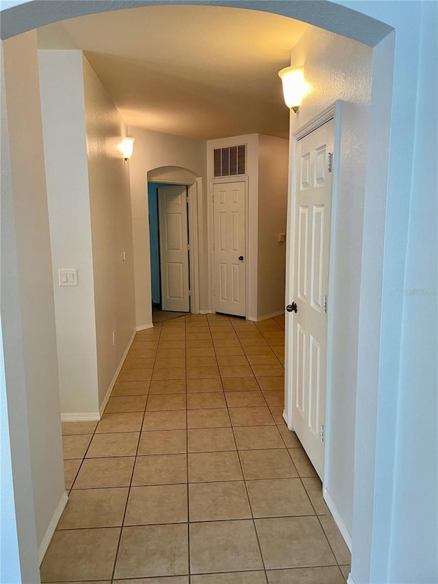 hall with light tile patterned floors