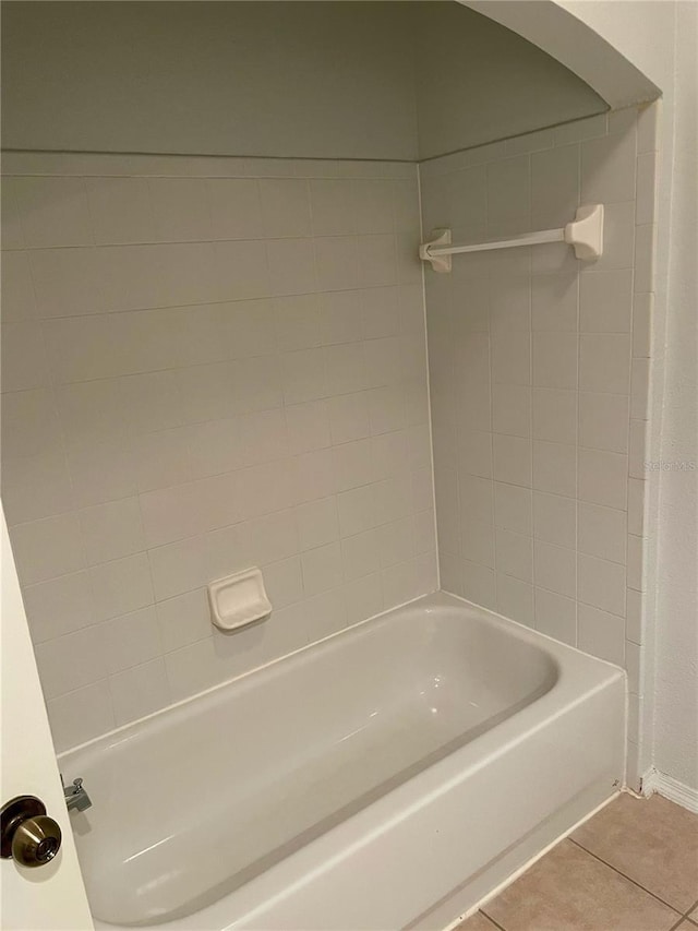 bathroom with tile patterned flooring and tiled shower / bath