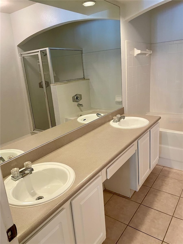 bathroom with vanity, enclosed tub / shower combo, and tile patterned flooring