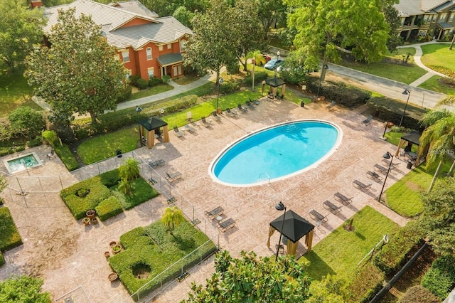 view of pool with a patio and a lawn