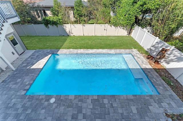 view of swimming pool with a lawn and a patio area