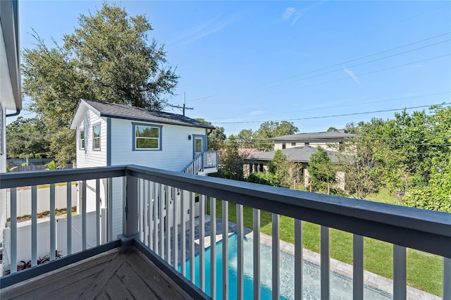 wooden terrace with a fenced in pool