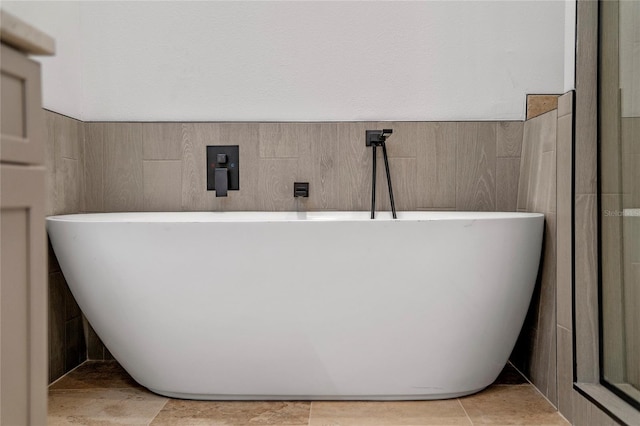 bathroom with a bathtub and tile patterned floors