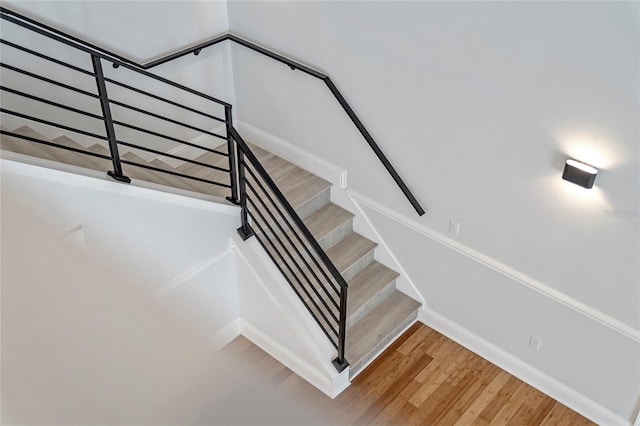 stairs featuring hardwood / wood-style flooring