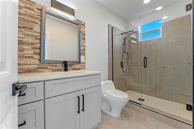 bathroom featuring tile patterned floors, toilet, tasteful backsplash, vanity, and walk in shower