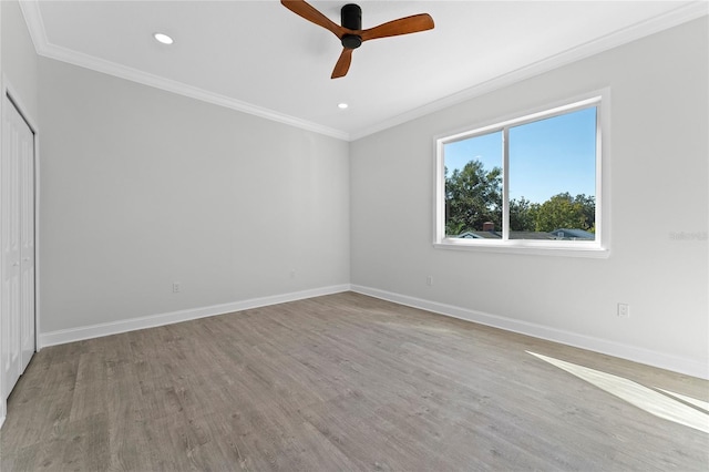 unfurnished room with ceiling fan, crown molding, and light hardwood / wood-style flooring