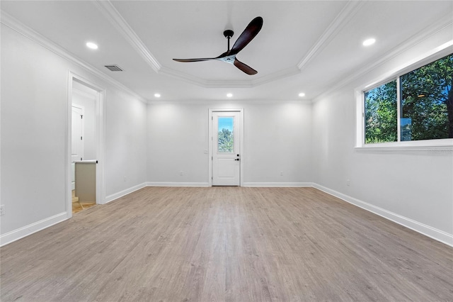 unfurnished room featuring ornamental molding, light hardwood / wood-style flooring, a healthy amount of sunlight, and ceiling fan