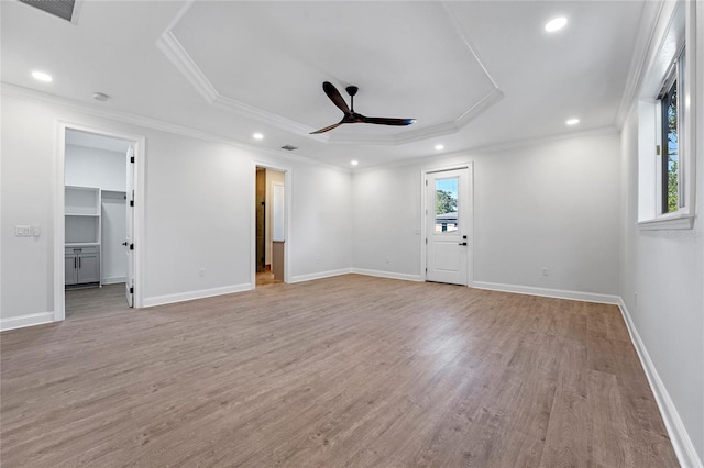 empty room with ornamental molding, plenty of natural light, ceiling fan, and light hardwood / wood-style flooring