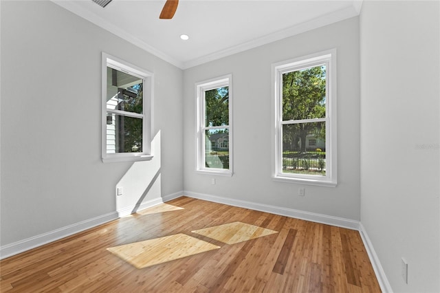 unfurnished room with ornamental molding, light wood-type flooring, and ceiling fan