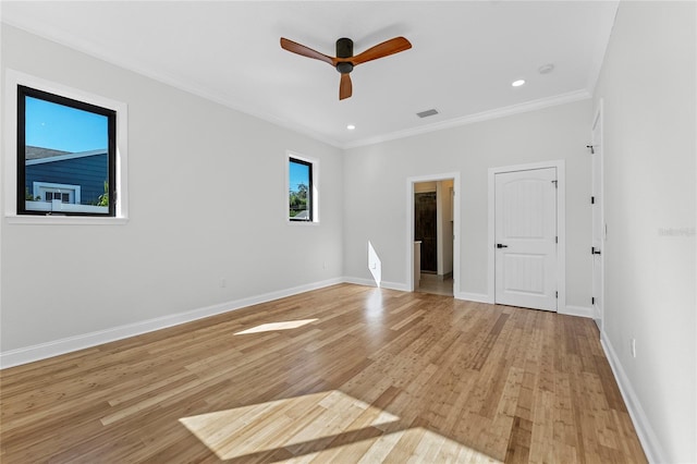 empty room featuring ceiling fan, crown molding, and light hardwood / wood-style flooring