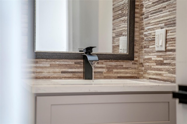 room details featuring decorative backsplash and sink