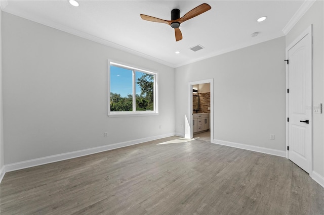 interior space featuring hardwood / wood-style flooring, ceiling fan, ornamental molding, and ensuite bathroom