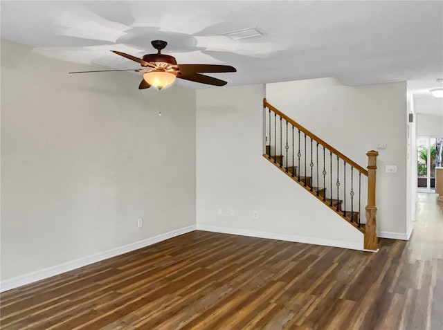 spare room with dark wood-type flooring and ceiling fan