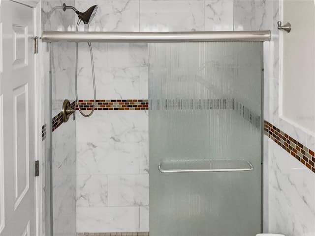 bathroom with a shower with shower door