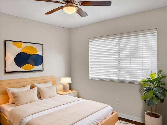 bedroom with hardwood / wood-style flooring and ceiling fan