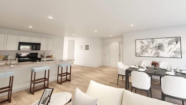 interior space featuring sink and light wood-type flooring