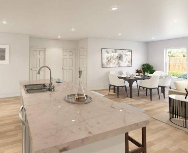 dining room featuring sink and light hardwood / wood-style flooring