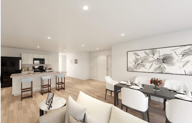 living room featuring sink and light hardwood / wood-style flooring