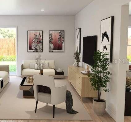 living room featuring light hardwood / wood-style flooring and plenty of natural light