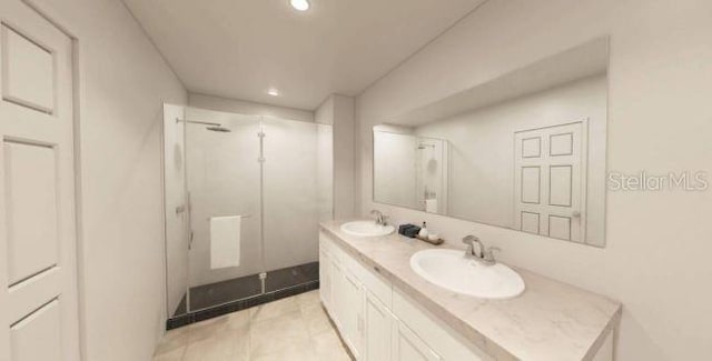 bathroom featuring vanity and a shower with shower door