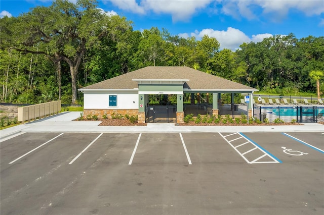 view of car parking featuring a community pool