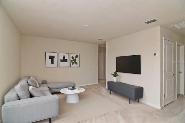 carpeted living room featuring a textured ceiling