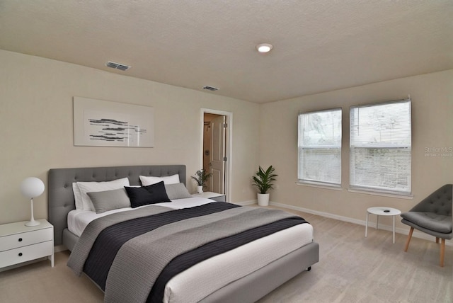 carpeted bedroom featuring a textured ceiling